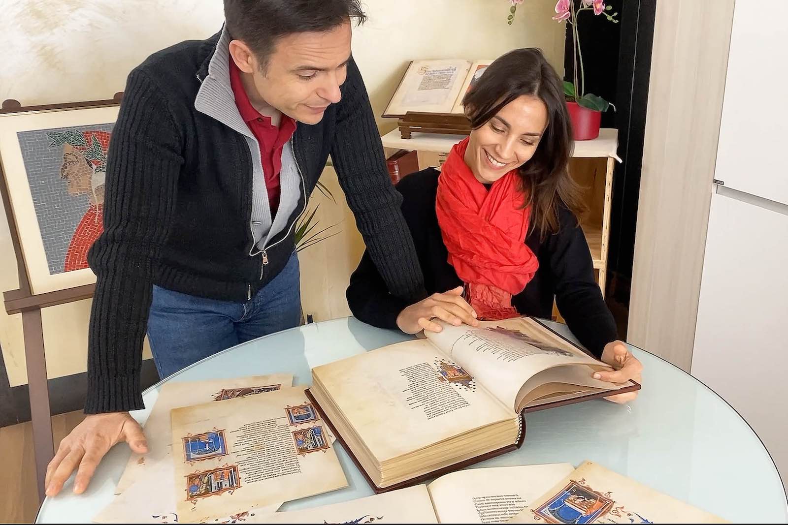Giovanni and Giulia leafing through a facsimile