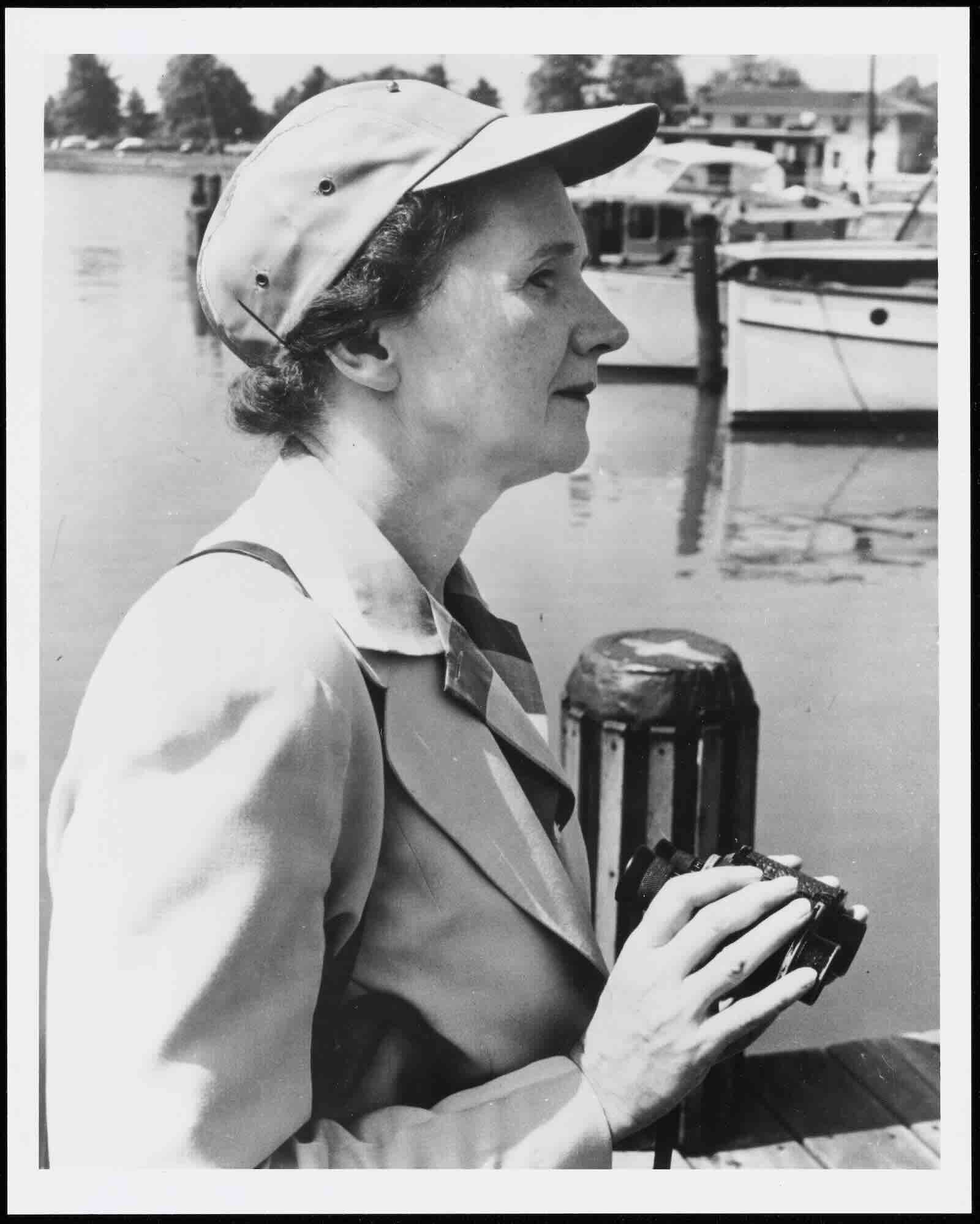 Rachel Carson holding binoculars, 1951, by Norman Driscoll