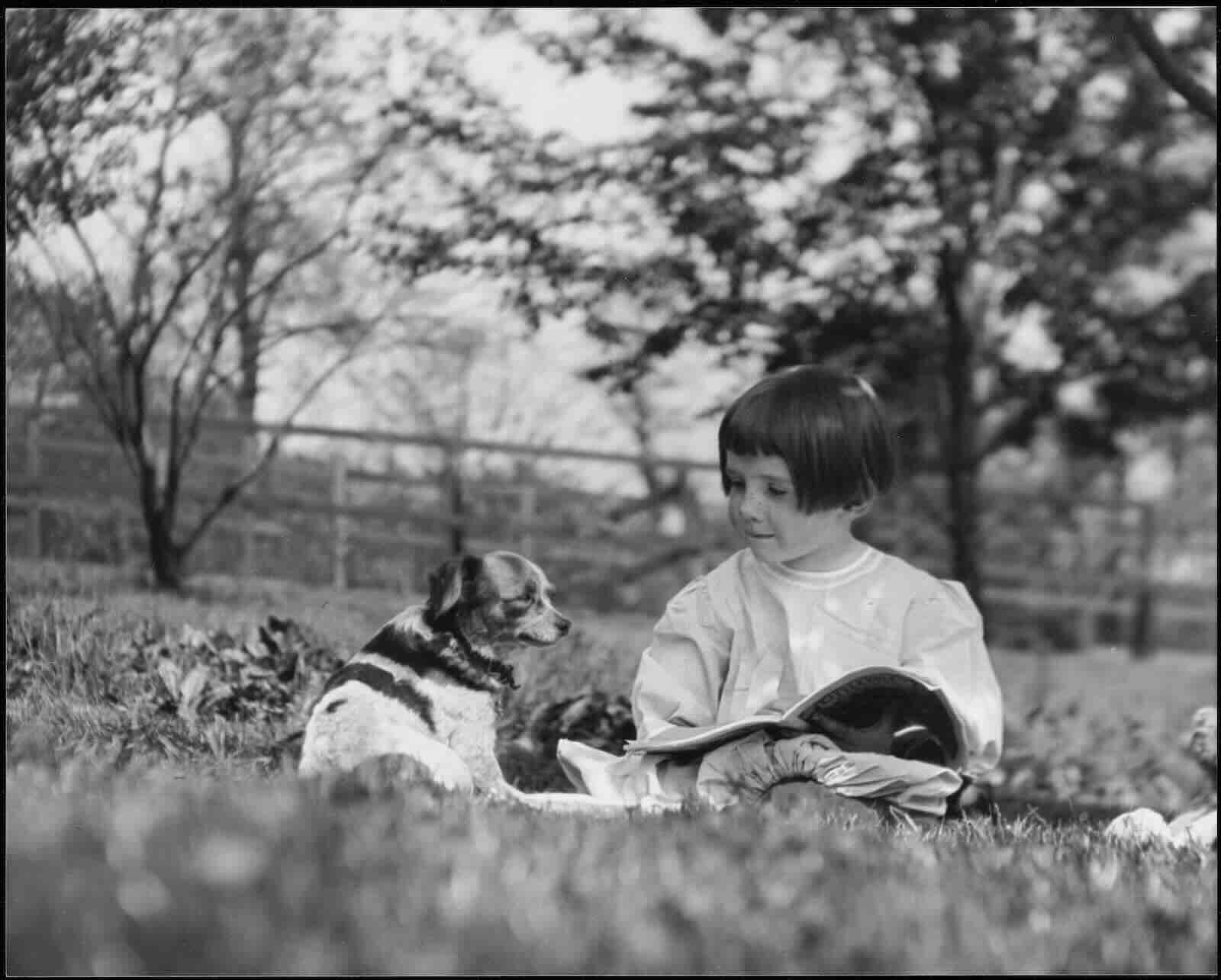 Rachel Carson reading to her dog, ca. 1912