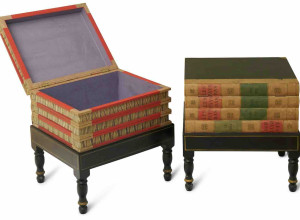 Two library occasional tables of faux books formed as a stack of books on a stand, the spines marked 'LES PAYS BAS' with hinged top lids and marbled paper interiors, on ebonised integral stands, part of the John Laws Collection auction
