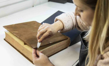 Paper conservator Jen Snowden working on Francis Austen’s mathematics coursebook from the Royal Naval Academy at Portsmouth.