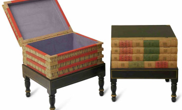 Two library occasional tables of faux books formed as a stack of books on a stand, the spines marked 'LES PAYS BAS' with hinged top lids and marbled paper interiors, on ebonised integral stands, part of the John Laws Collection auction