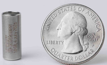 A one gigabyte synthetic DNA storage vial encoded with digital copies of Library collection items alongside a quarter 