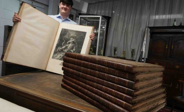Auctioneer Jack Orgill with the books