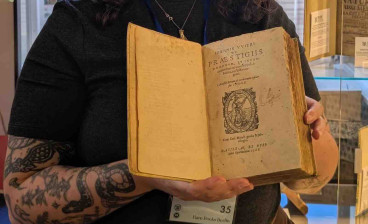 Clare Marshall of Marshall Rare Books with the expanded edition of Johann Weyer's Praestigiis Daemonum, Et Incantationibus ac ueneficiis