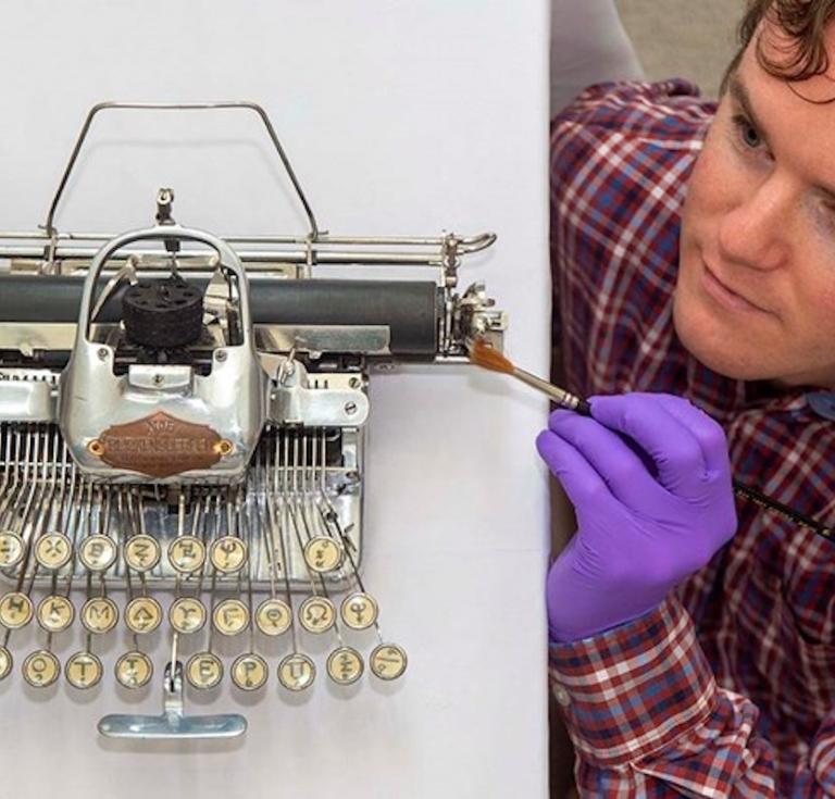 James Inglis brushing a Blickensderfer featherweight typewriter