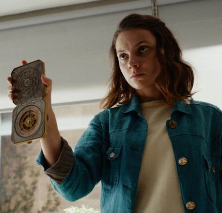 Lyra brandishes her alethiometer in the television series