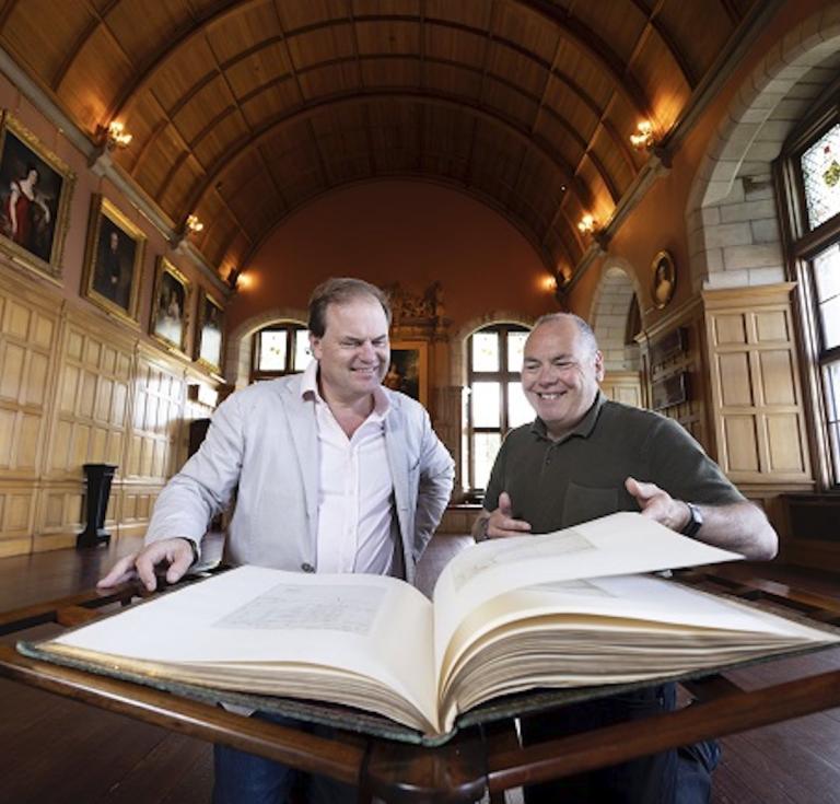 Lord Dalmeny (left) and Professor Gerard Carruthers (right) of the University of Glasgow at Barnbougle Castle looking through the Burnsiana book.
