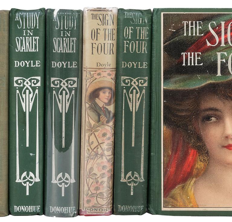 Several books with green and beige spines and one with a cover with a woman's face