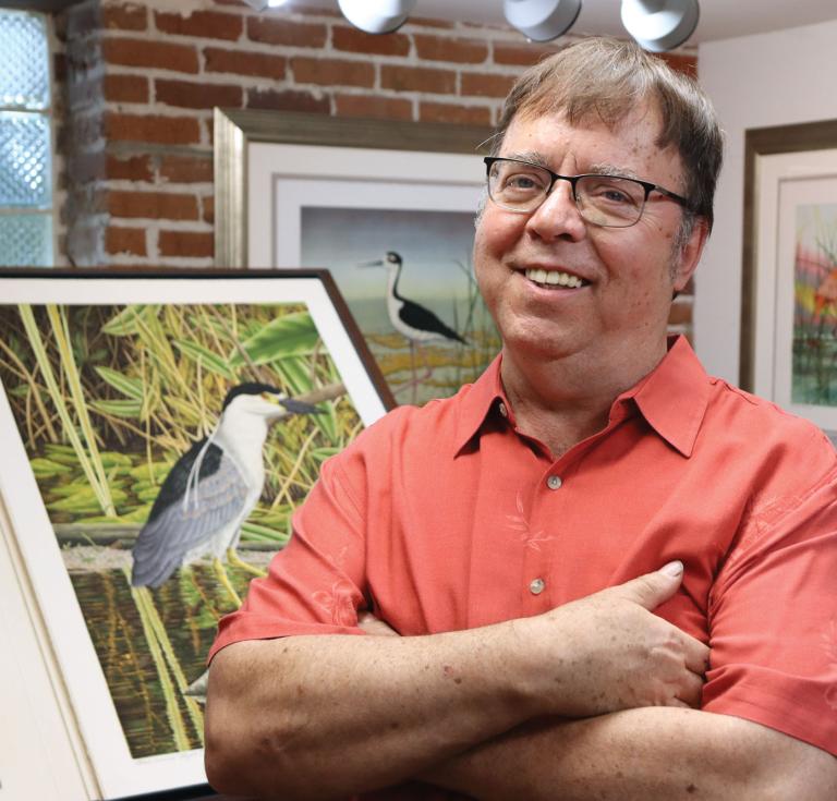 photograph of artist John Costin with a depiction of a bird