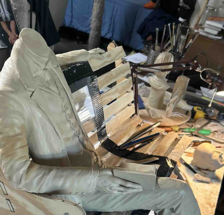 Robert Louis Stevenson figure and bench structure during the sculpting process